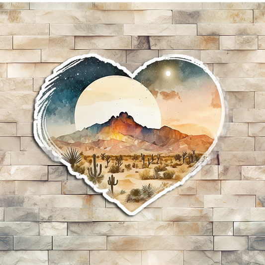 A desert night scene with the moon rising over the distant mountains. This vinyl sticker is in the shape of a heart.