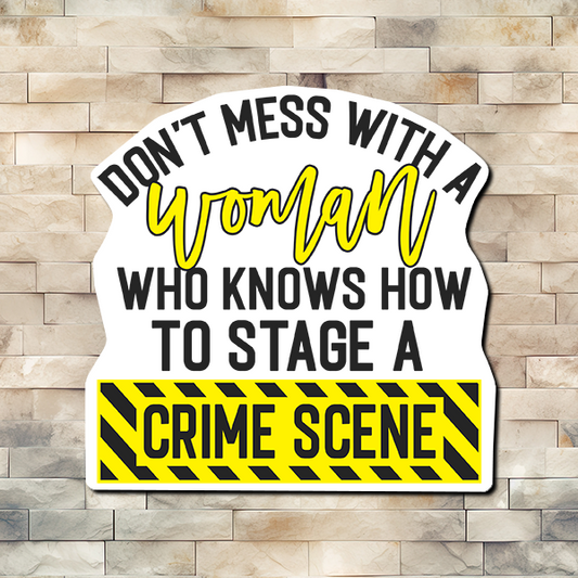 In Yellow and Black like crime scene tape. Words are typed "Don't mess with a Woman who knows how to stage a CRIME SCENE." Vinyl Sticker